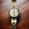 Elegant Rolex Lady Date 25mm watch with gold and silver bracelet. Perfect for luxury watch collector.