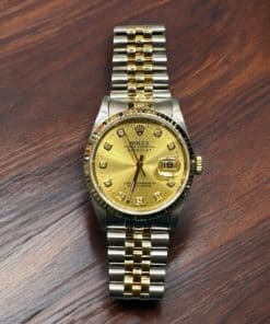 Rolex Datejust 36mm luxury watch with gold dial and diamond hour markers. Perfect for collectors and.